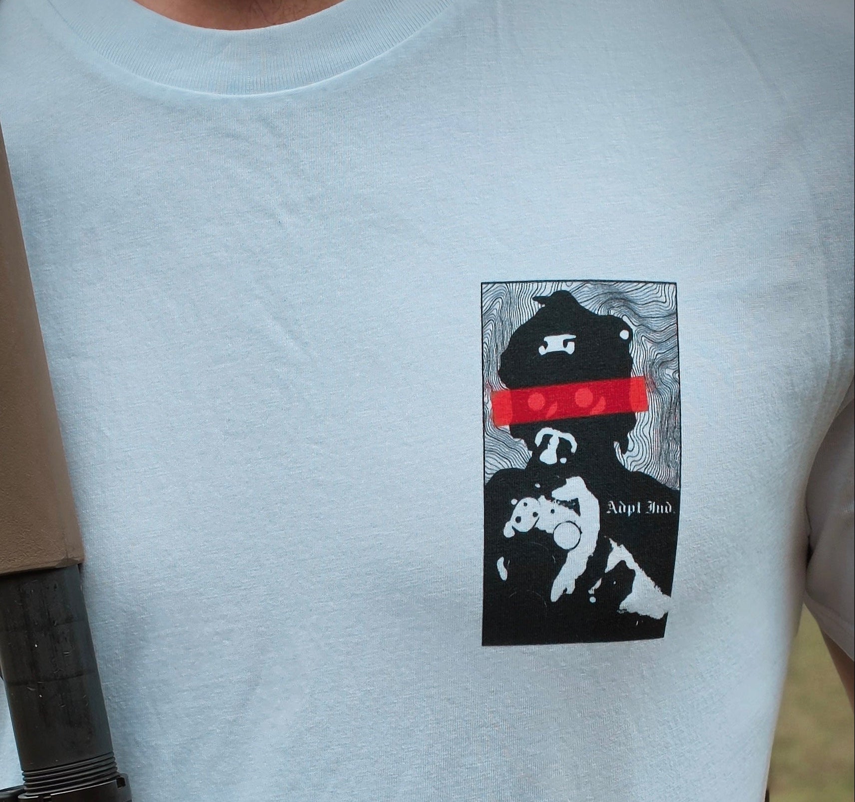 Person wearing a white t-shirt with a graphic design