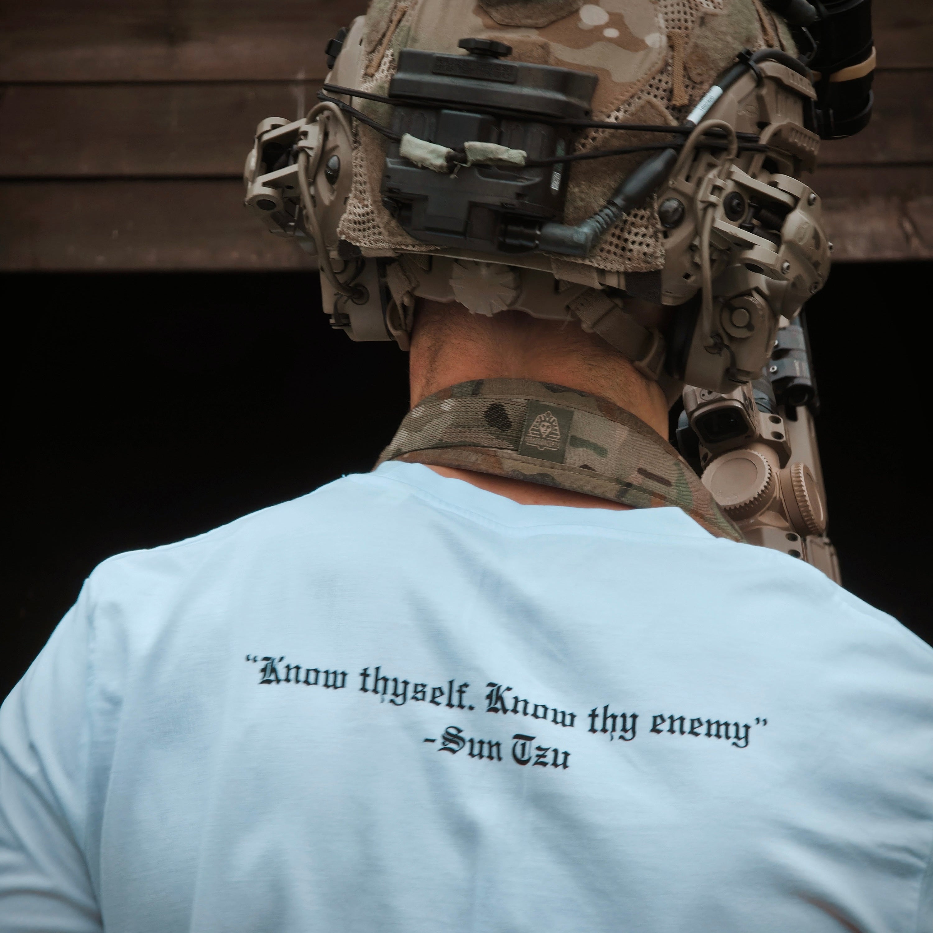 Person wearing a helmet with a quote on a white t-shirt