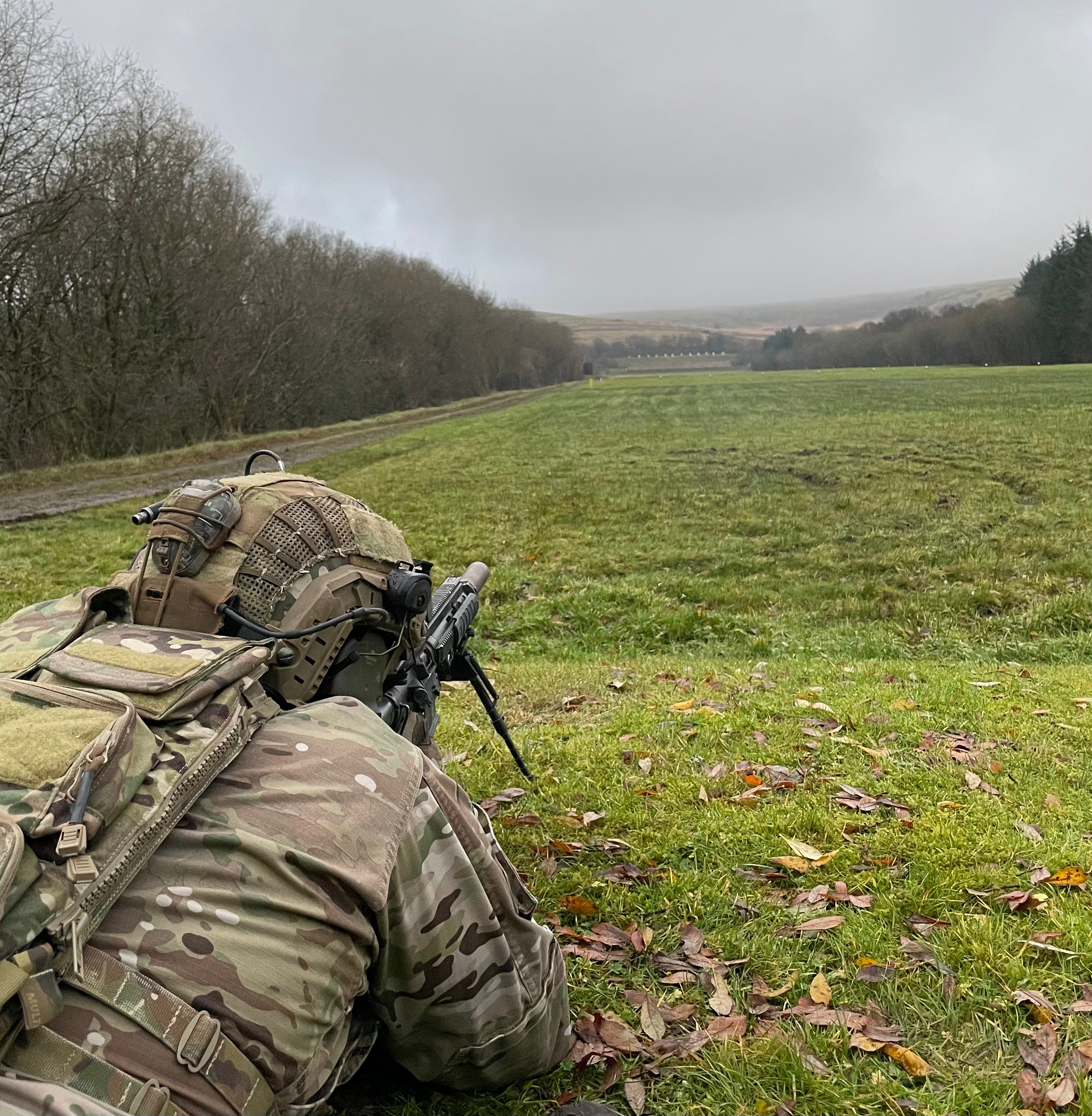 Soldier in tactical kit firing a sharp shooter rifle