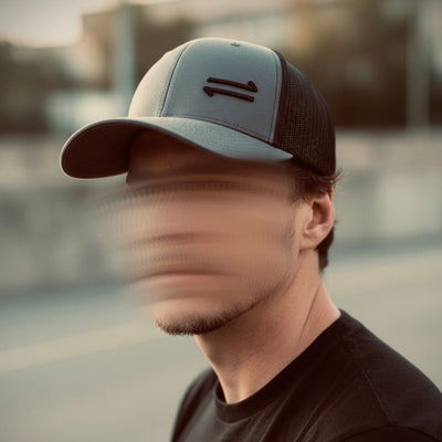 Person wearing a cap with a blurred face in an outdoor setting