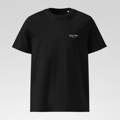 Black t-shirt with a small white logo on a light gray background